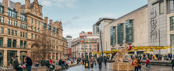 Manchester city centre in the UK. Heritage buildings sit alongside newer ones in an open square