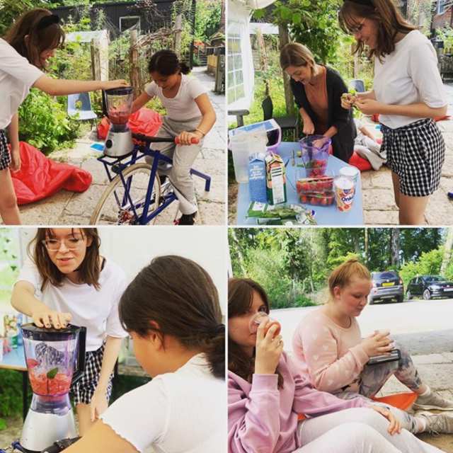 Four images of women enjoying an outdoor smoothie making workshop – two women chop fruit, another powers a blender using a bike and two girls drink cups of the fruit smoothie.