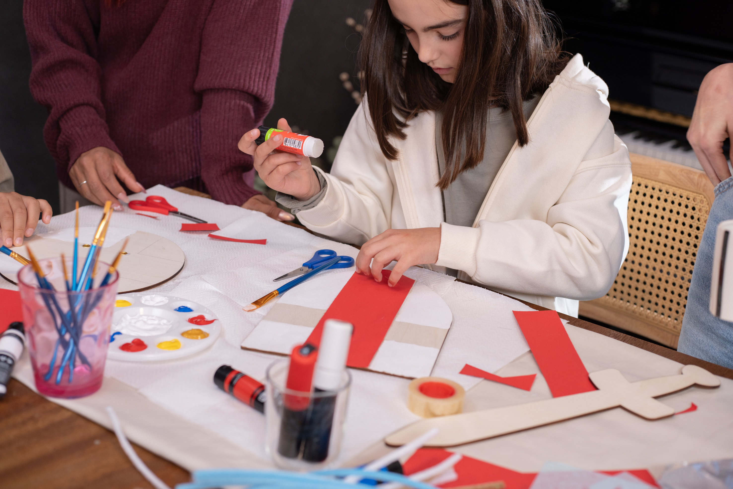 A child sticking paper and cardboard together as part of an arts session