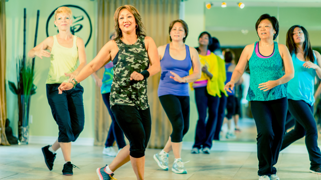 A group of women of varying ethnicities dance at a studio