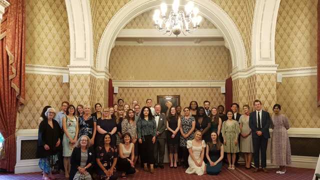 A group of people standing for a photo in a formal room. The group 			includes the 23 healthcare students who make up the 2021 cohort of the National Social Prescribing Student Champions Scheme