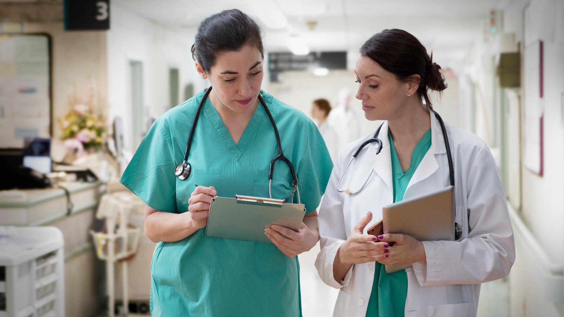 Two female doctors look at a chart 