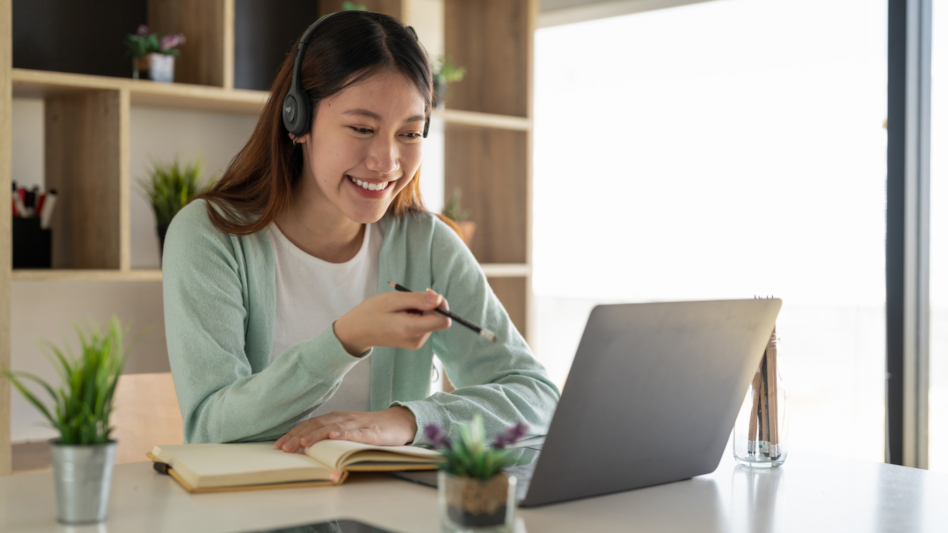 Woman on laptop with headset 
