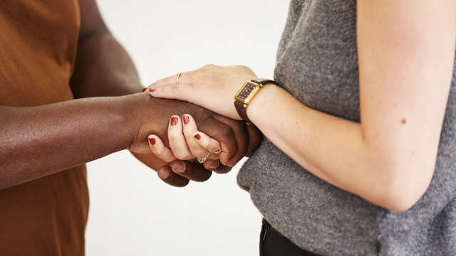 Two people clasp hands