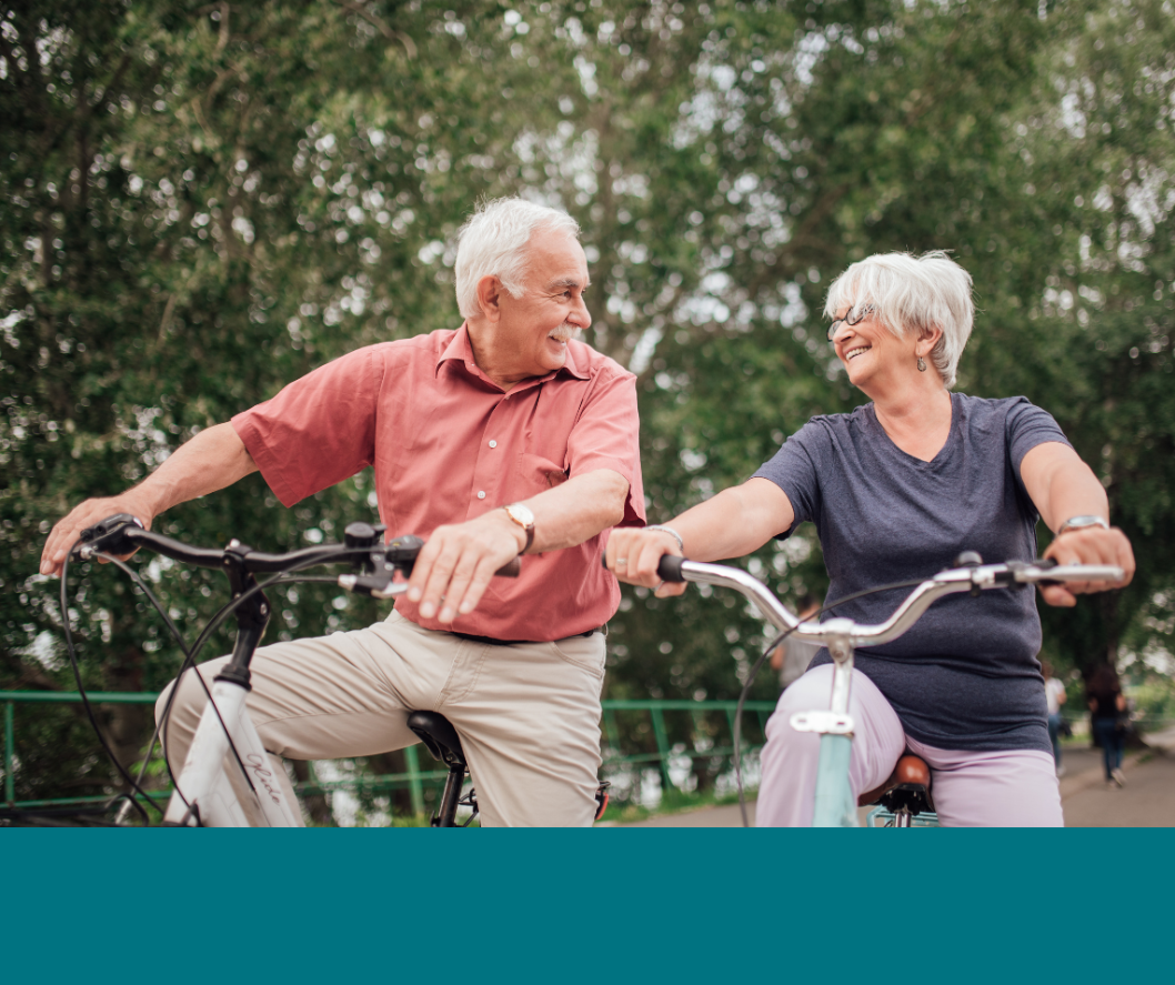 Elderly couple cycling outdoors