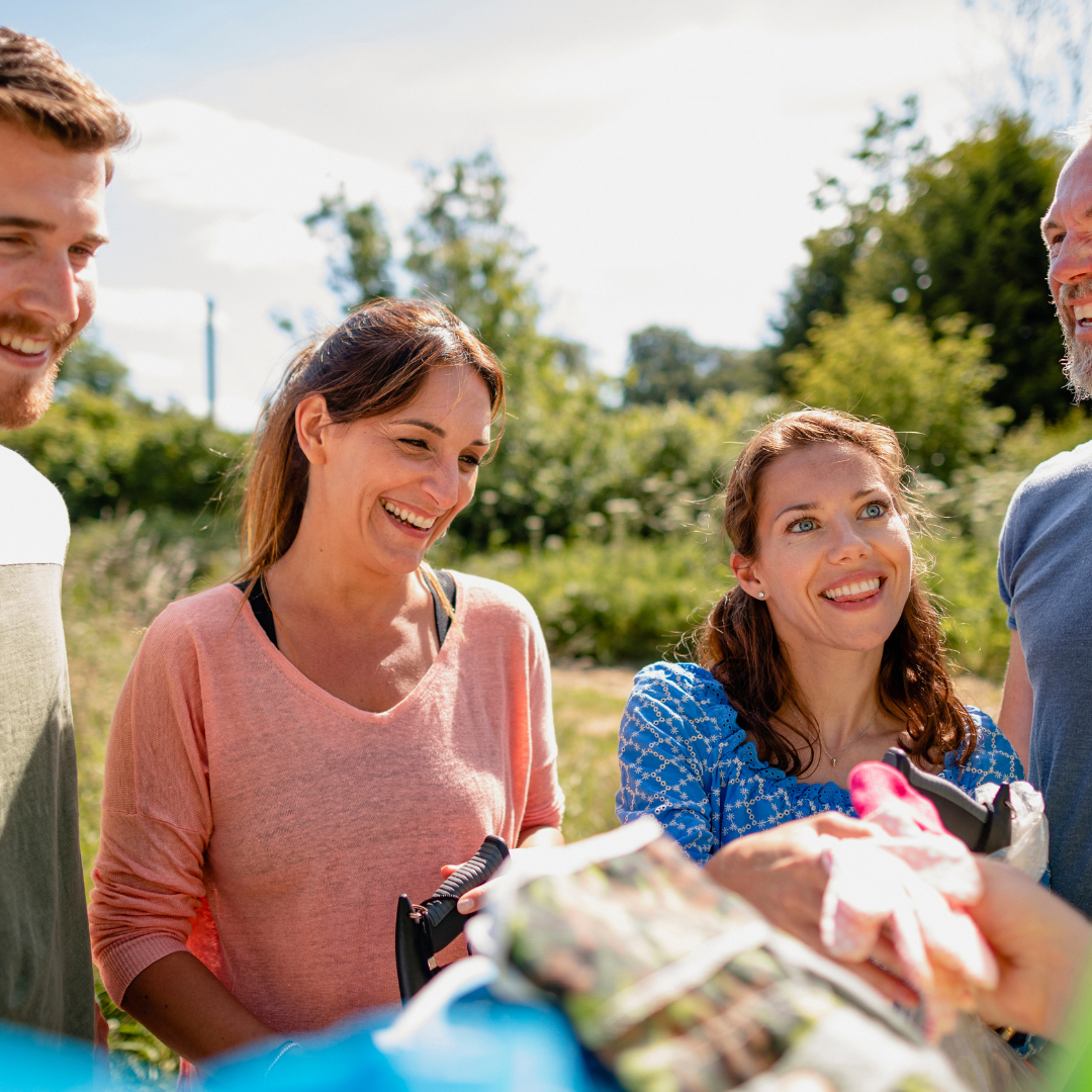 A group of people voluntering in a garden 