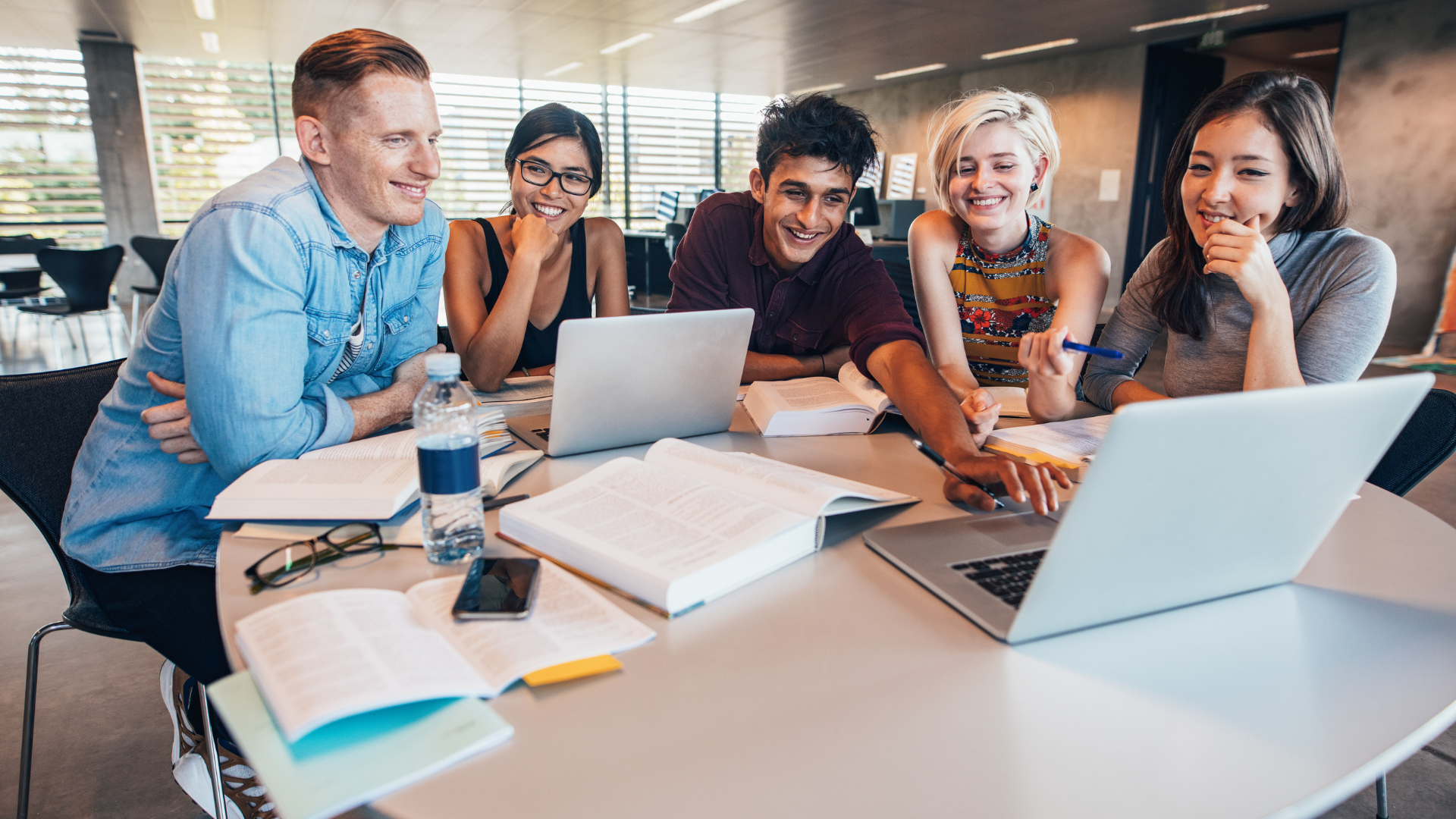 students sitting together working in a library 