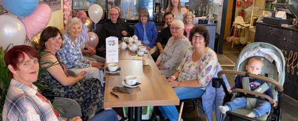 A group of people of different generations meet up at a Friends for You in a café in Chorley