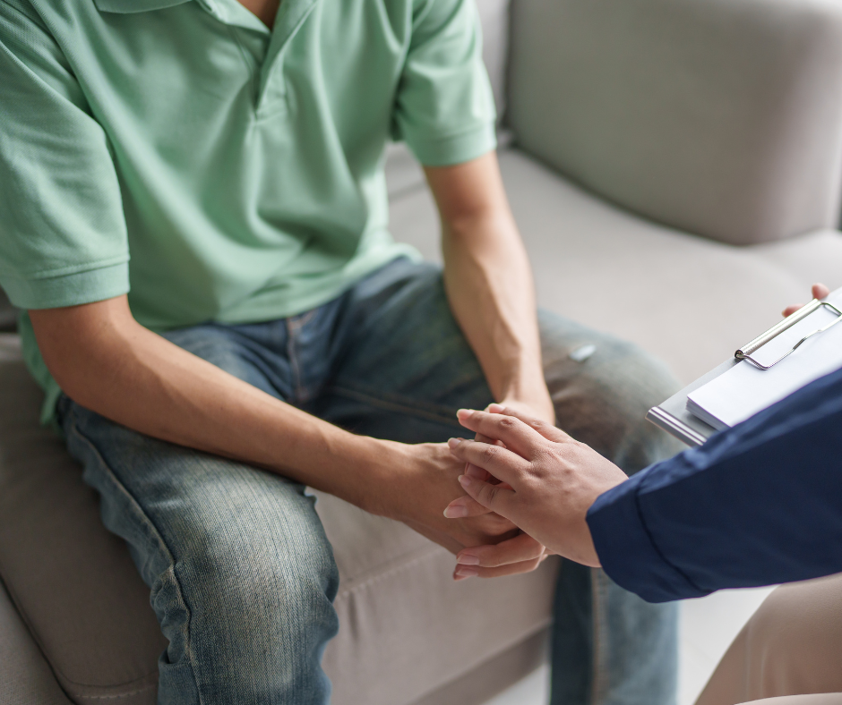 A man sat down speaking with a mental health expert