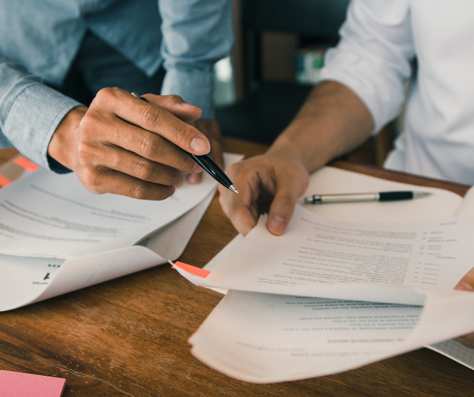 A pair of hands sorting through papers