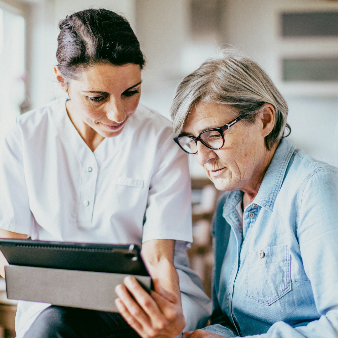 NHS provider shows patient their notes on a digital tablet