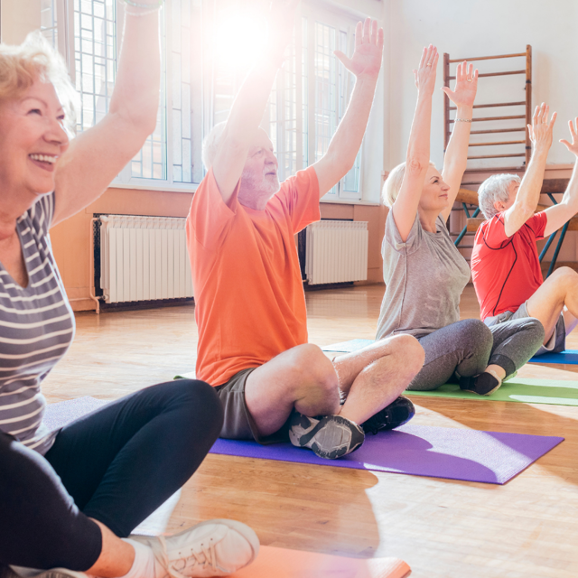 A group of adults take part in an exercise class