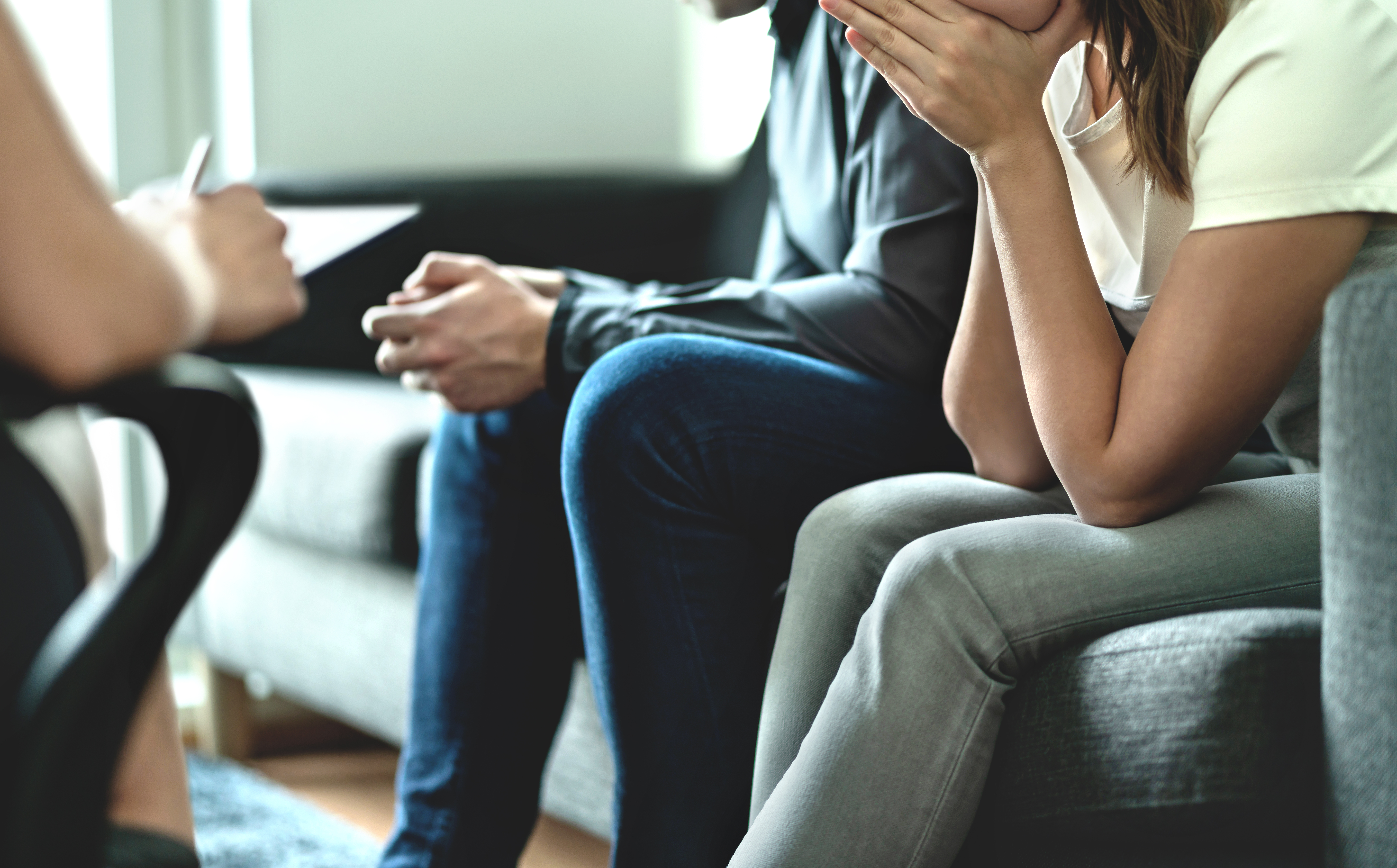 A couple receiving counselling or advice sitting on sofas 