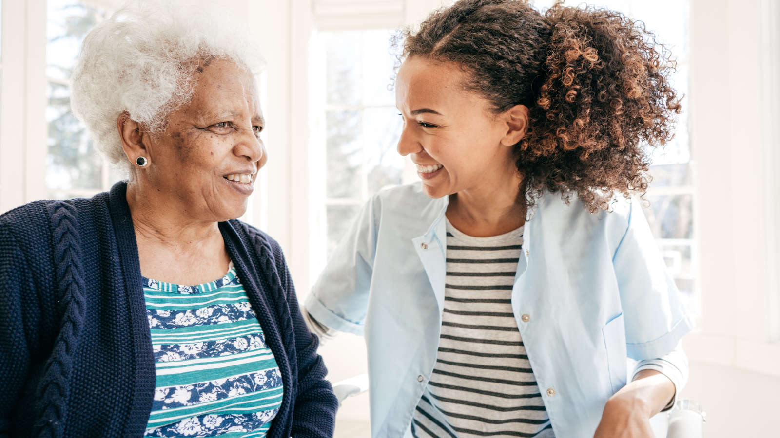 A young woman sits and talks to and older woman