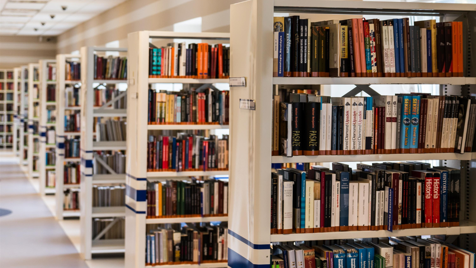 Several shelves of academic books stacked up in a library 