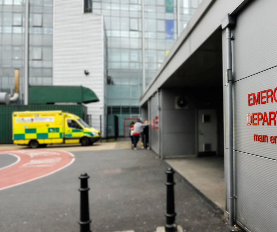 An ambulance is parked at the door of an accident and emergency hospital department 