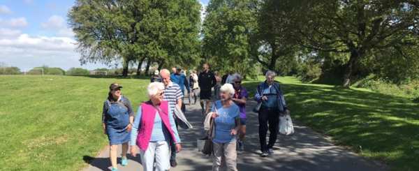 A group of older people attending a walk and talk in a Plymouth park 