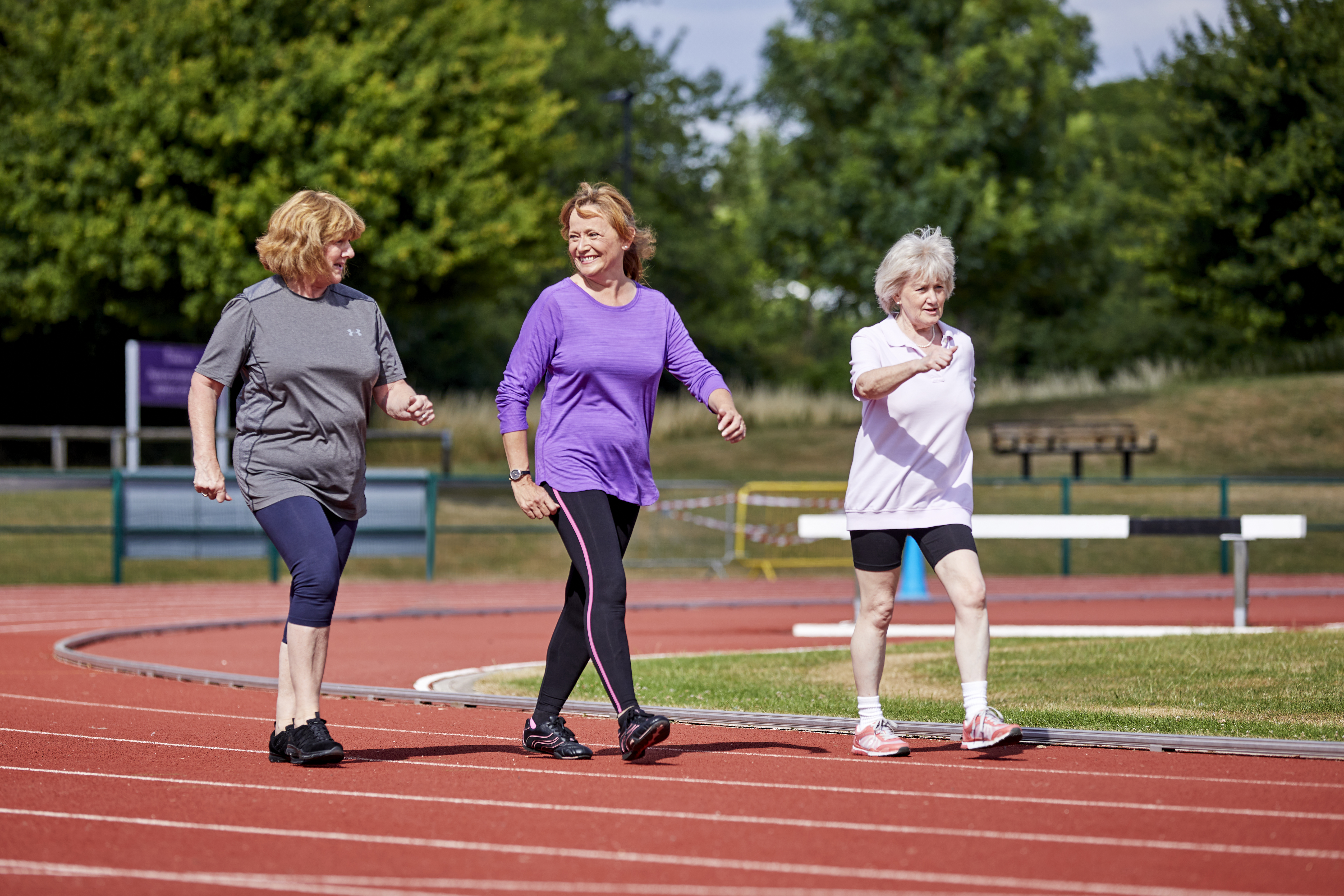 Four women enjoying a walk in the ground of a sports centre 