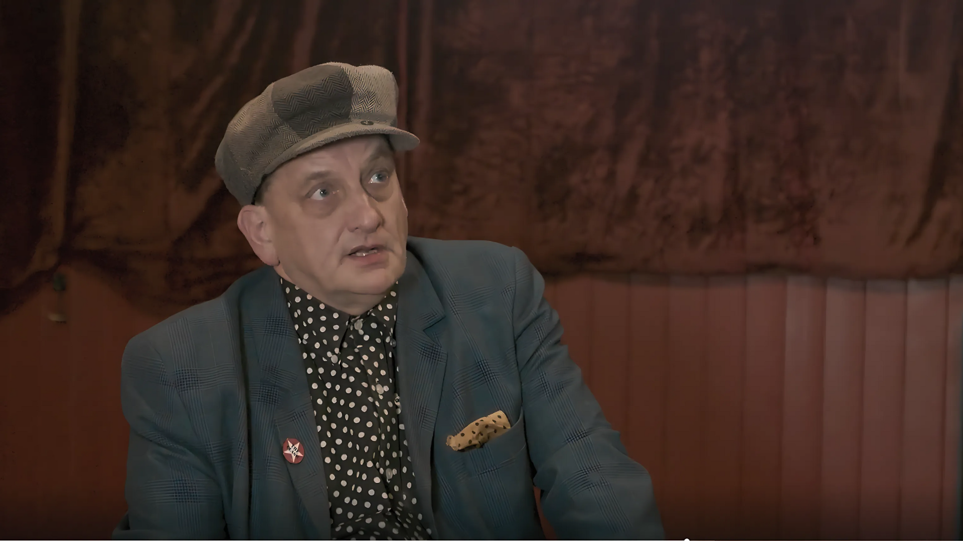 A man in a hat and suit 