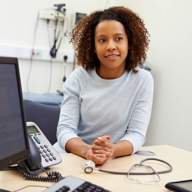 A mixed race women meets with a doctor