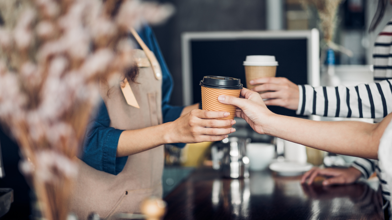 Customers in a cafe purchasing hot drinks 